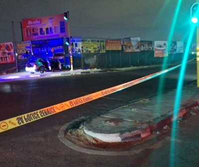 Crime scene at Crown Mines where police fatally shot five suspects linked to cash-in-transit heists, vehicle abandoned at traffic lights with doors open.