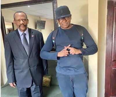 Johannesburg businessman Malcolm X standing next to former Hawks head General Godfrey Lebeya at an event.