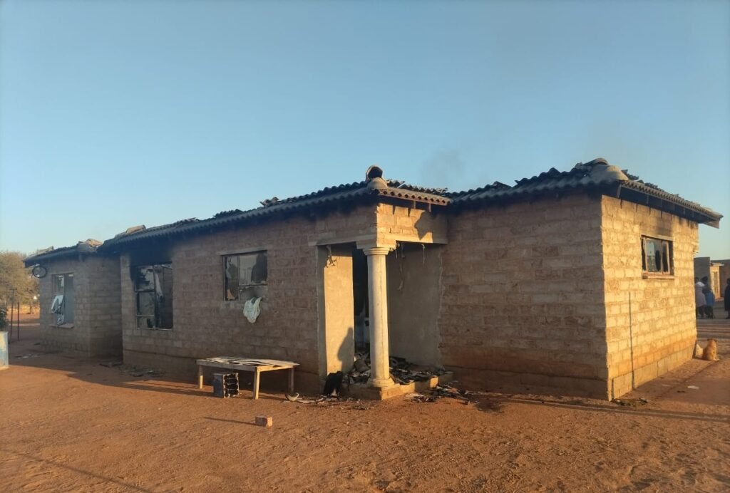 Burnt exterior of the Villa Nora house with missing windows and blackened walls