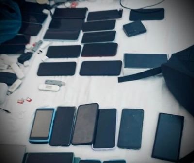 SAPS officers during cybercrime raid at Durban beachfront hotel linked to cellphone phishing syndicate arrests